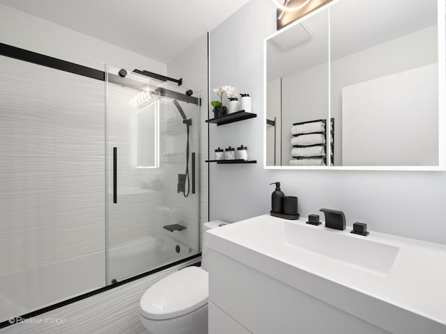 full bathroom with shower / bath combination with glass door, vanity, toilet, and radiator heating unit