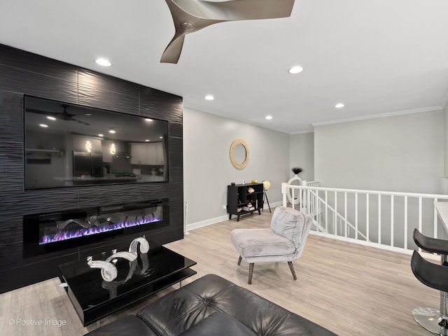 living room featuring ornamental molding and light wood-type flooring