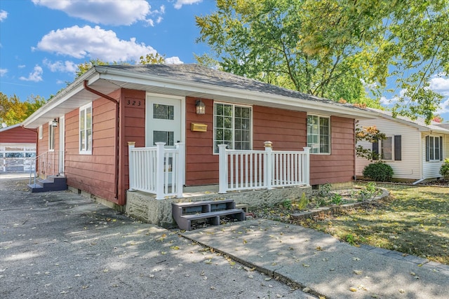 ranch-style home with a garage and an outbuilding