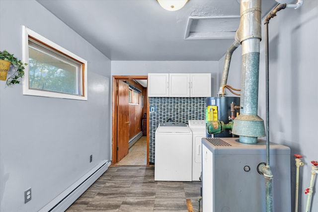 laundry room featuring cabinets, washer and dryer, baseboard heating, and water heater