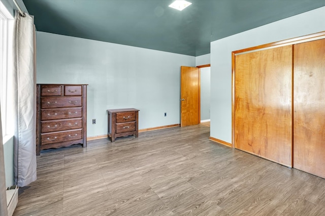 unfurnished bedroom featuring a closet and light hardwood / wood-style floors