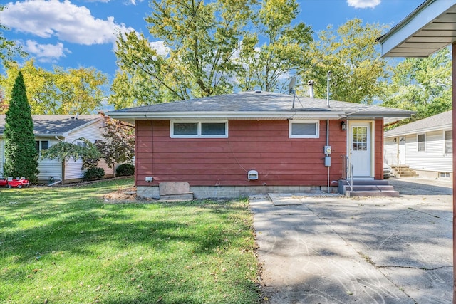 back of house with a lawn and a patio area