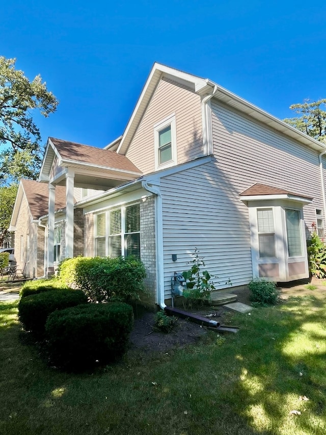 view of home's exterior with a yard