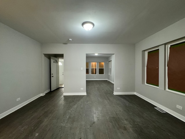 empty room featuring dark wood-type flooring