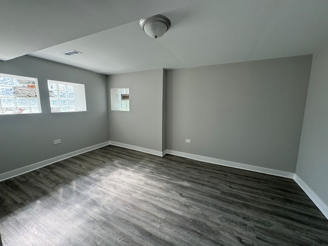 unfurnished room featuring dark wood-type flooring