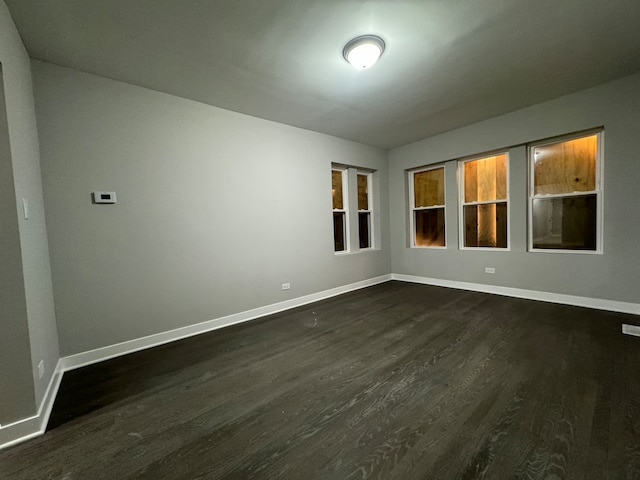 spare room with dark hardwood / wood-style floors