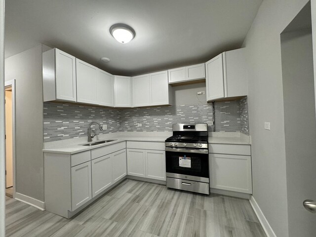 6830 S Michigan Ave, Chicago, IL 60637 - kitchen with stainless steel gas range oven, a sink, light countertops, backsplash, and light wood-style floors