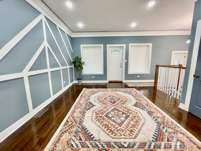 foyer with crown molding and dark wood-type flooring