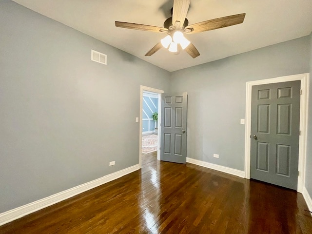 unfurnished room with ceiling fan and dark hardwood / wood-style floors