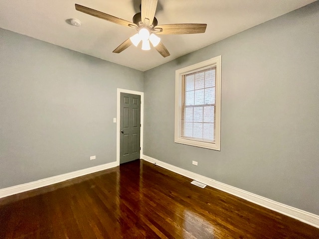 unfurnished room featuring ceiling fan and dark wood-type flooring