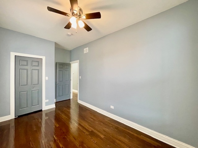 unfurnished bedroom with dark hardwood / wood-style floors and ceiling fan