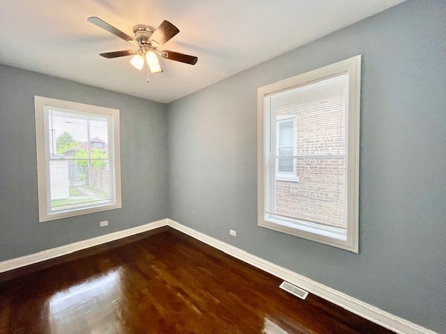 empty room with ceiling fan and hardwood / wood-style flooring