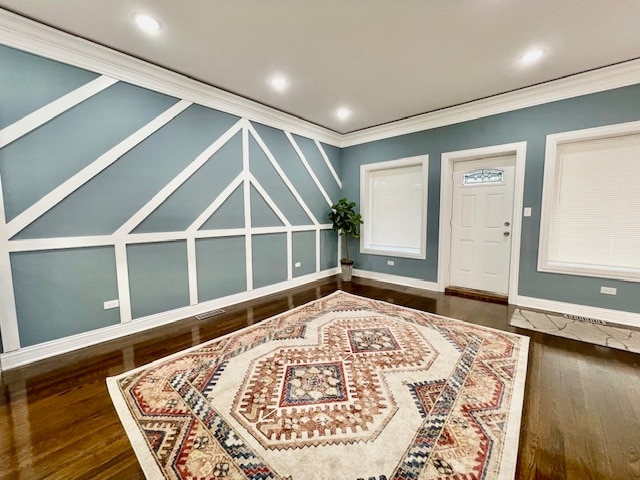 sitting room featuring ornamental molding and dark wood-type flooring