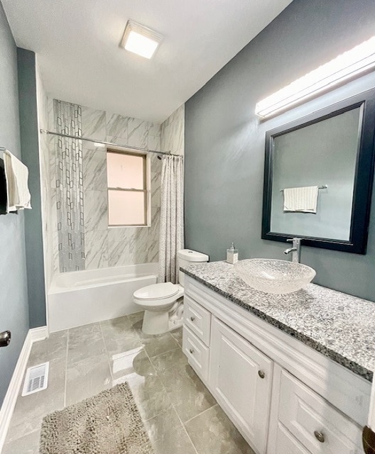 full bathroom featuring shower / tub combo with curtain, vanity, and toilet