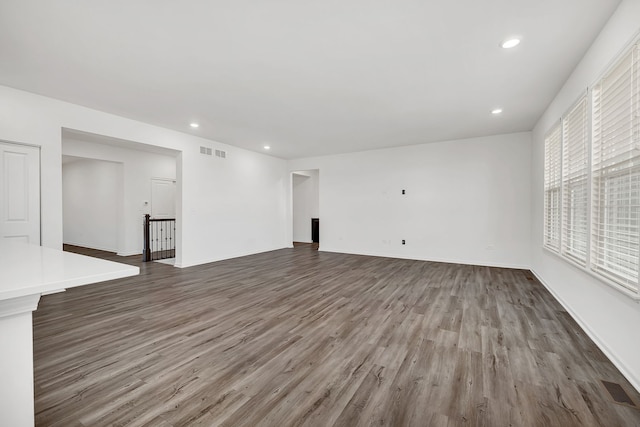 unfurnished living room featuring dark hardwood / wood-style floors