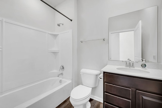 full bathroom with hardwood / wood-style floors, bathing tub / shower combination, vanity, and toilet