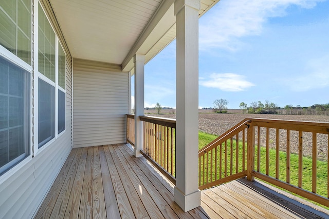 wooden deck featuring a lawn