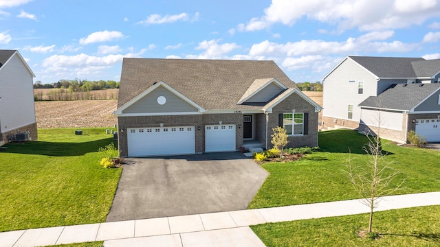 view of front of home with a garage, cooling unit, and a front lawn