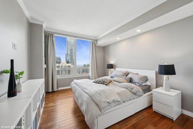 bedroom featuring crown molding and dark hardwood / wood-style floors