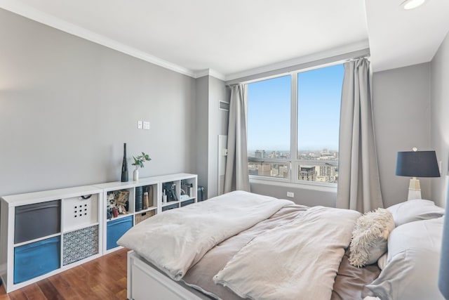 bedroom featuring ornamental molding and dark wood-type flooring