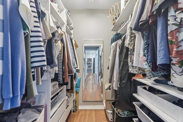 spacious closet with light hardwood / wood-style floors