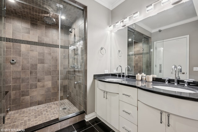 bathroom featuring ornamental molding, tile patterned flooring, a shower with door, and vanity