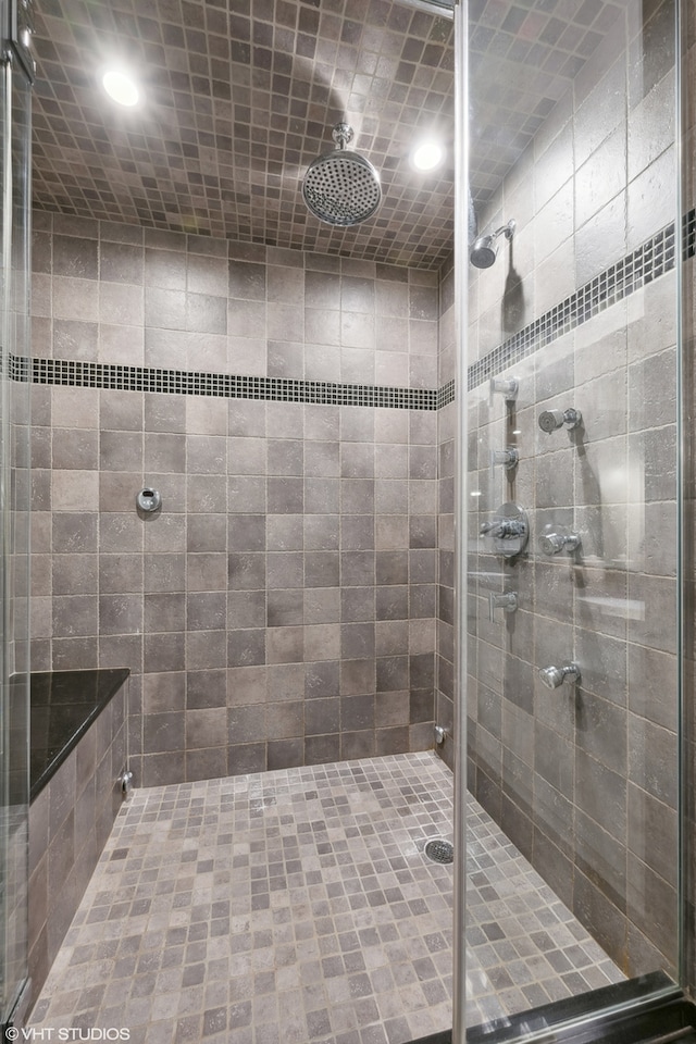 bathroom featuring a shower with shower door