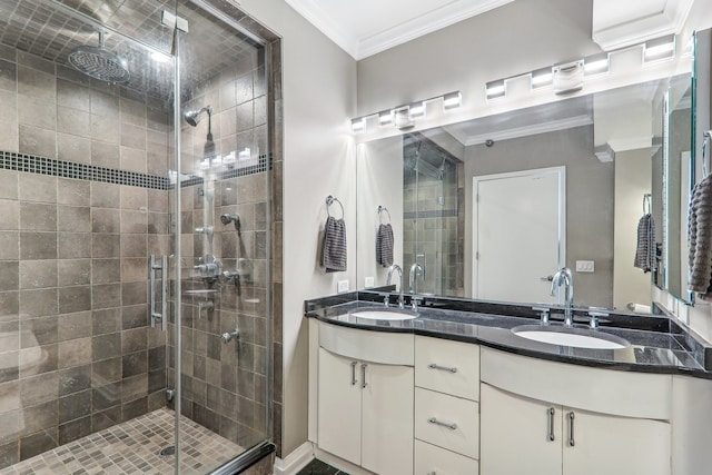 bathroom featuring ornamental molding, vanity, and an enclosed shower