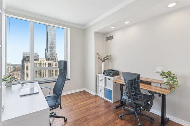 home office featuring hardwood / wood-style floors and crown molding