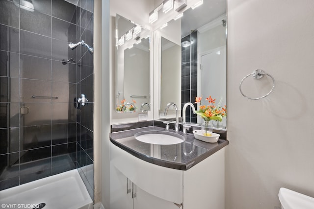 bathroom with vanity, a shower with shower door, and toilet