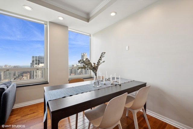 dining room with hardwood / wood-style flooring and ornamental molding