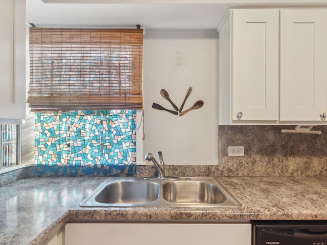 kitchen with white cabinets, tasteful backsplash, dishwasher, and sink