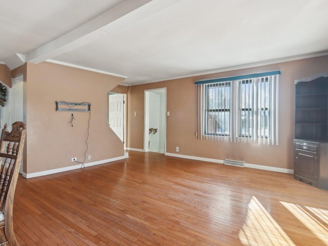 living room with beam ceiling, light hardwood / wood-style flooring, and ornamental molding