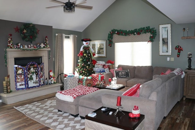 living room with dark hardwood / wood-style floors, ceiling fan, and lofted ceiling