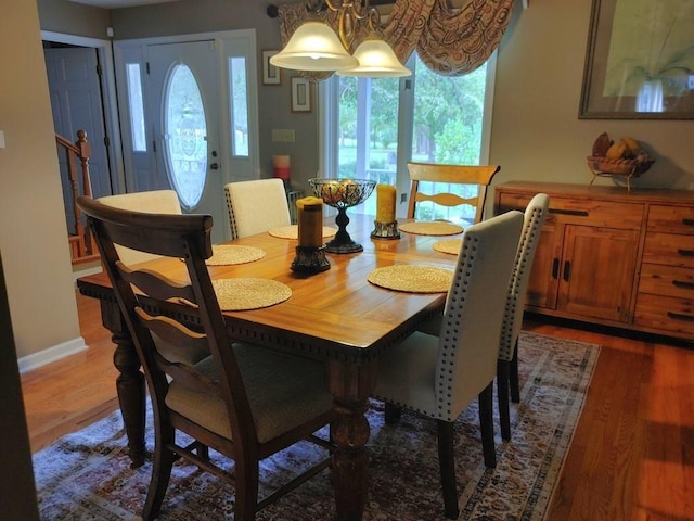 dining space featuring dark hardwood / wood-style floors and a notable chandelier