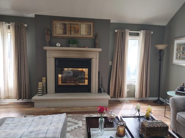 living area featuring hardwood / wood-style flooring and lofted ceiling