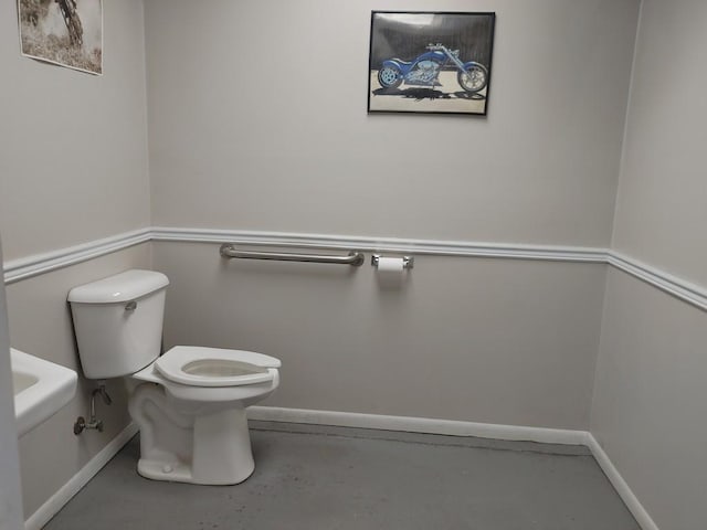 bathroom featuring concrete flooring and toilet