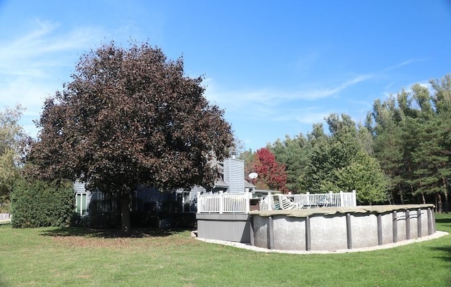 view of yard with a swimming pool side deck