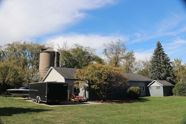 rear view of property featuring a yard