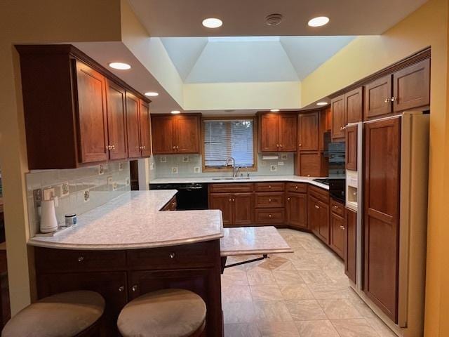 kitchen with kitchen peninsula, tasteful backsplash, sink, black appliances, and lofted ceiling