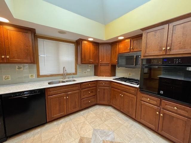 kitchen featuring tasteful backsplash, sink, and black appliances