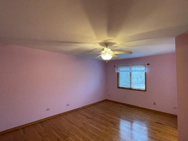 unfurnished room featuring hardwood / wood-style flooring and ceiling fan