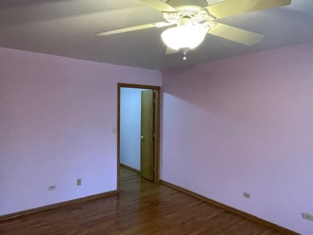 spare room featuring ceiling fan and dark hardwood / wood-style flooring