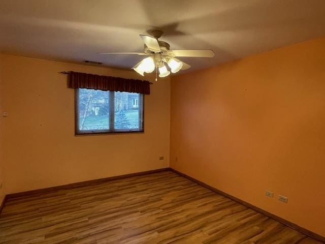 empty room featuring hardwood / wood-style flooring and ceiling fan