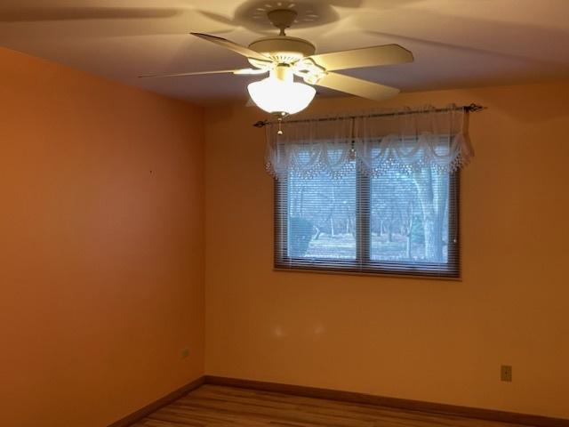 spare room featuring ceiling fan and hardwood / wood-style floors