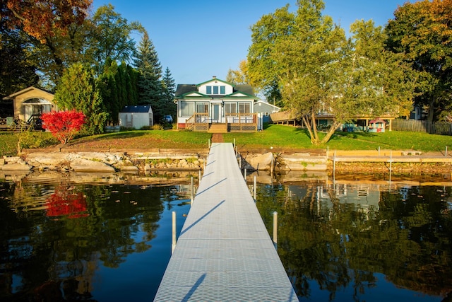 view of dock featuring a lawn, a gazebo, and a water view