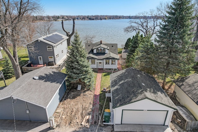 birds eye view of property with a water view