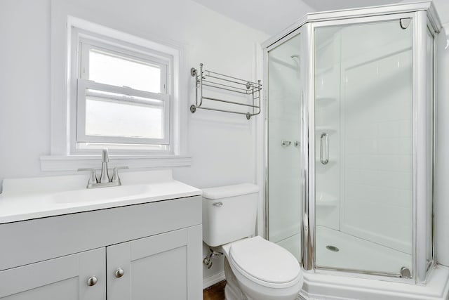 bathroom with vanity, toilet, and an enclosed shower