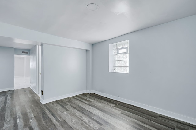 spare room with dark wood-type flooring