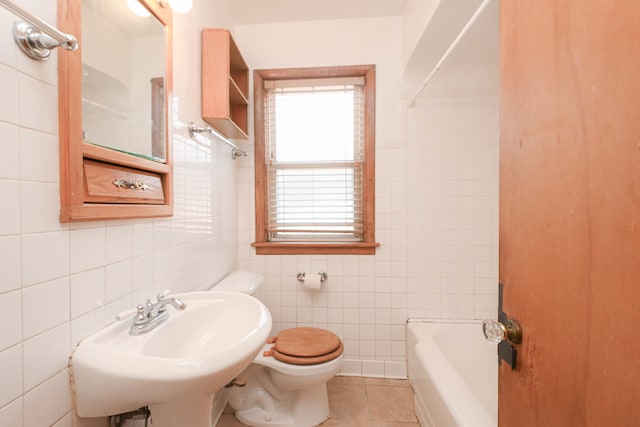 full bathroom with sink, shower / bathing tub combination, toilet, tile walls, and tile patterned flooring